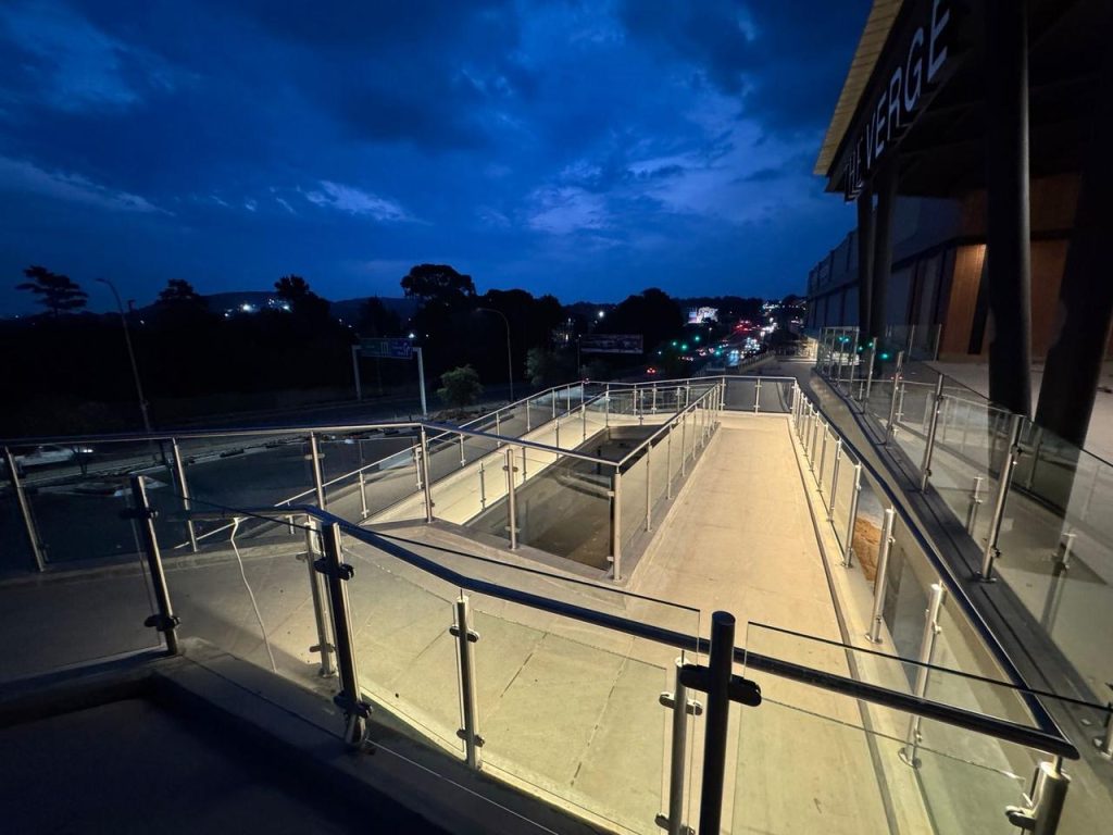 The Verge shopping centre walkway and railings during twilight.