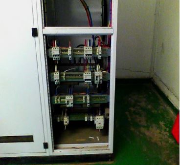 Electrical DB board showing circuit breakers and structured wiring.