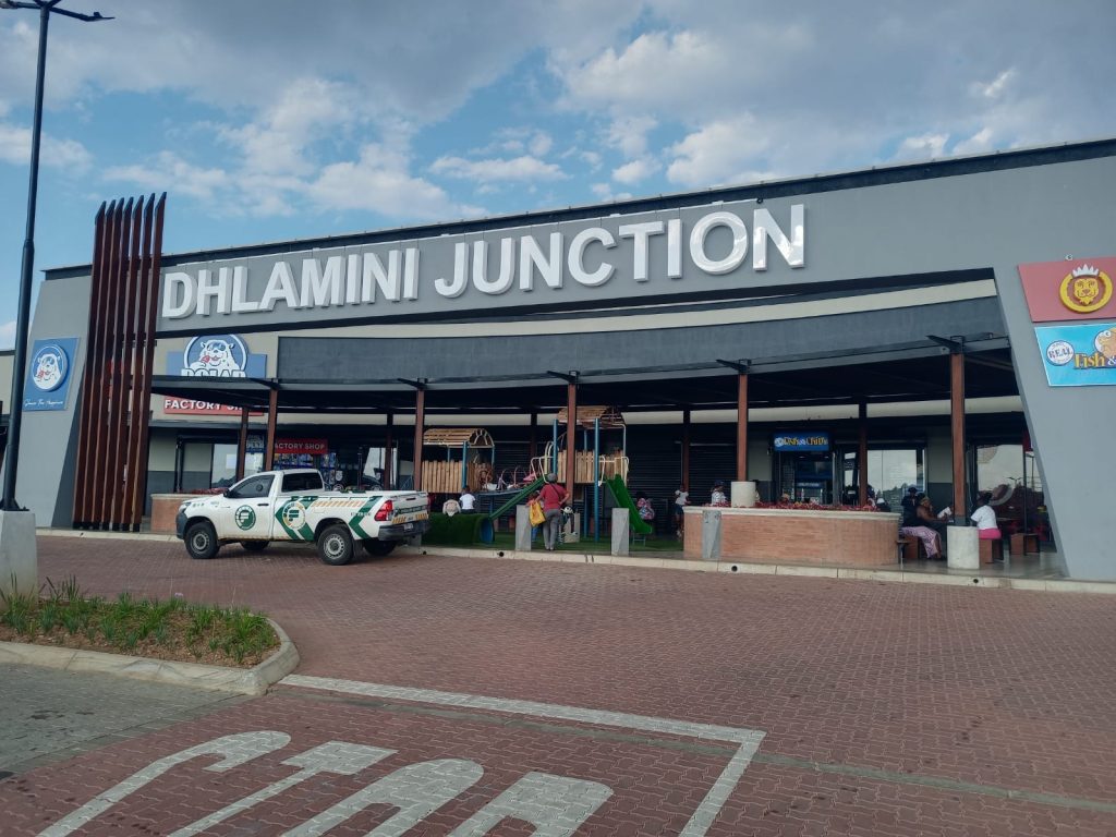 Front view of Dhlamini Junction shopping centre showing main entrance and parking area