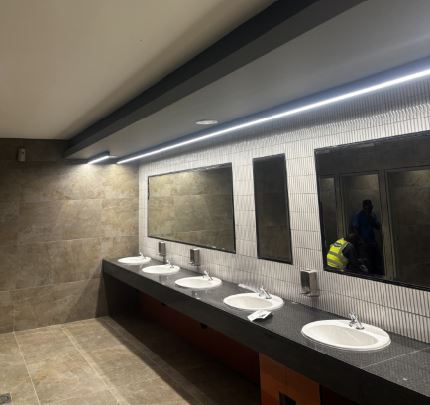 Modern restroom interior at Dhlamini Junction with sinks and mirrors