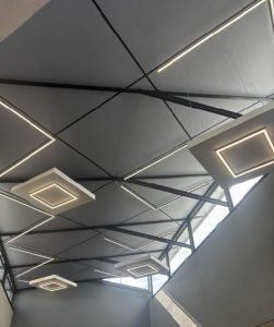 Retail walkway ceiling with geometric lighting fixtures at Dhlamini Junction