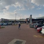 Wide-angle view of Dhlamini Junction showing parking and surrounding buildings