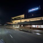 Wide night shot of The Verge Shopping Centre with full exterior illumination.