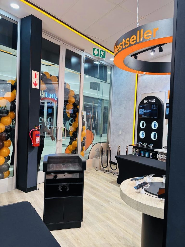 Cell C Galleria Mall retail interior featuring illuminated displays and concealed electrical conduit installations.