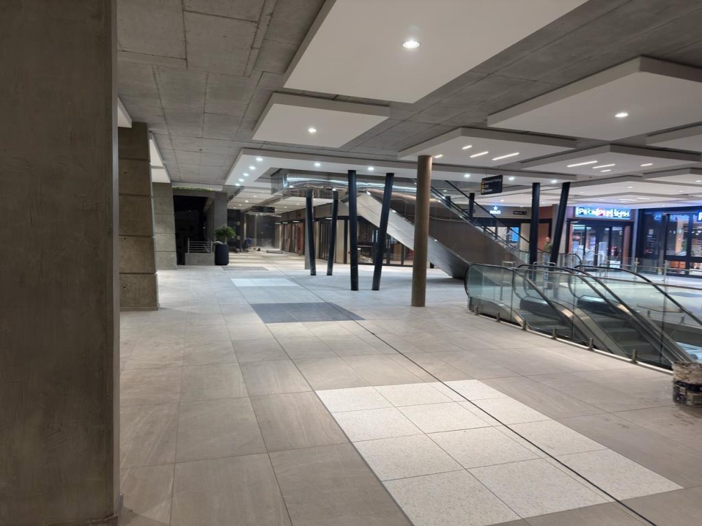 Interior entrance area at The Verge with ceiling lighting and tiled flooring.